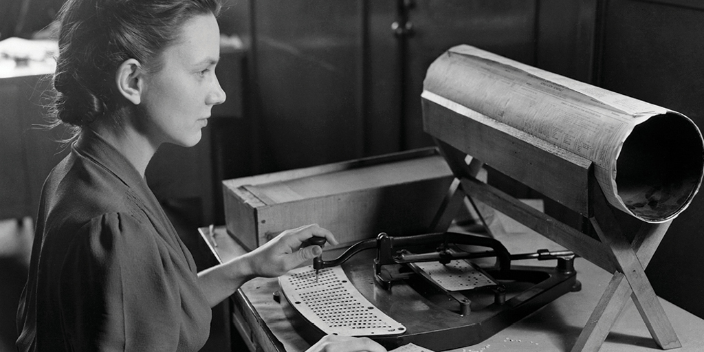 A woman operates a Hollerith pantograph punch, using its keyboard to create population cards for the 1940 U.S. Census.